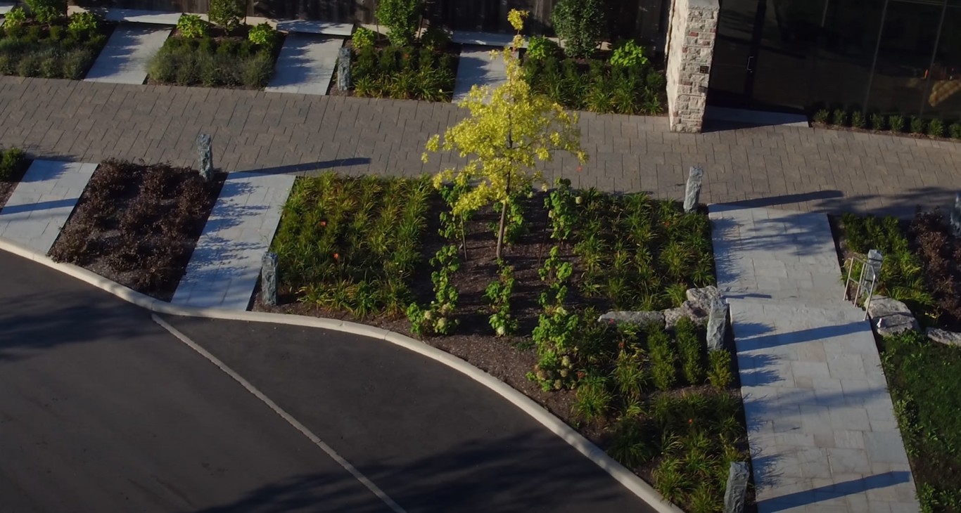 Aerial view of professional landscape design with mulch beds and paver walkways in Irondequoit, NY